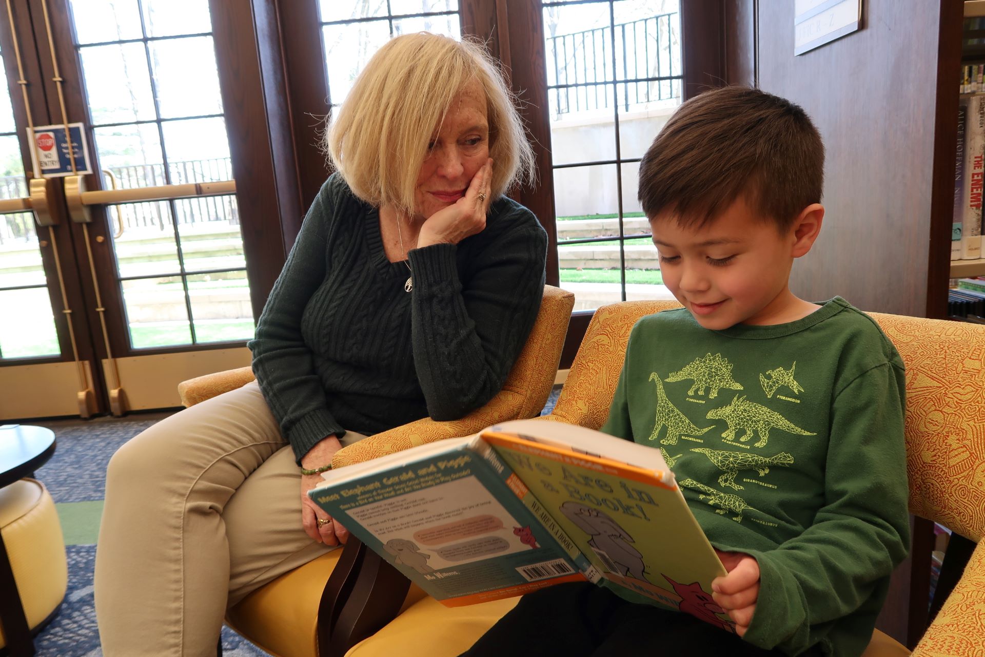 A woman and child read together in the children's room