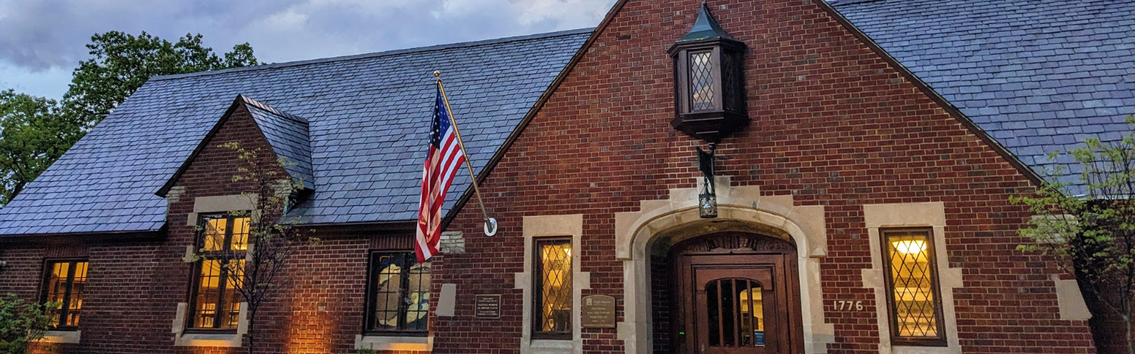 Front of the Wright Library building. A classic brick building with narrow windows on either side of the front door and a slate roof